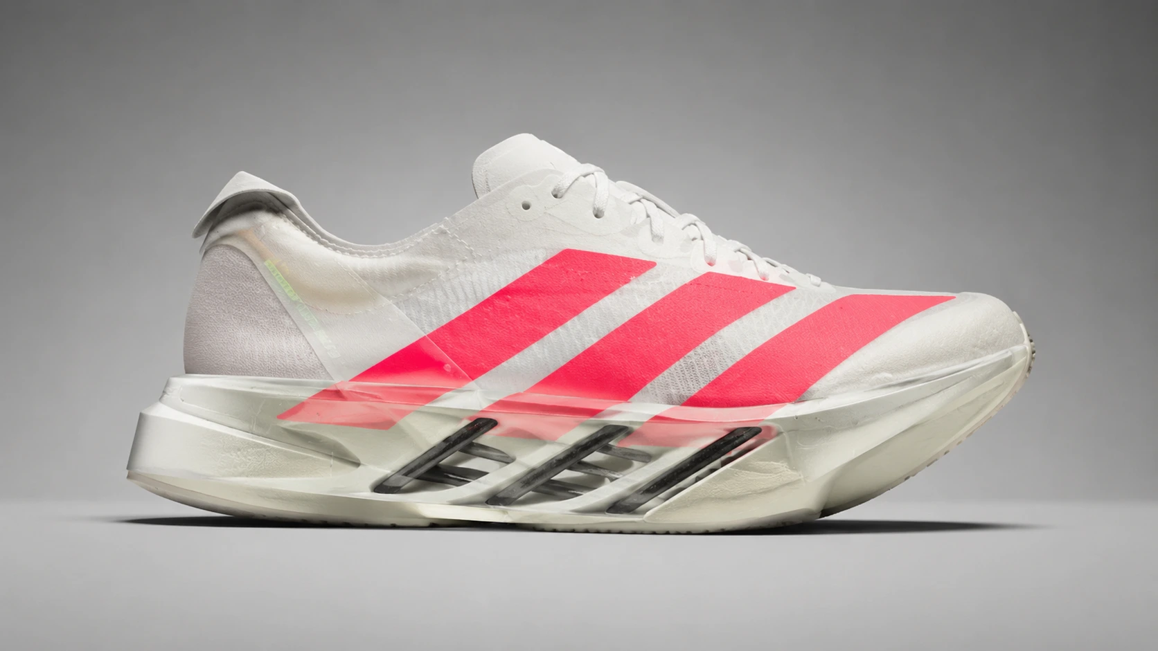 Side profile of Adidas Adios Pro 4 with visible carbon energy rods and Lightstrike Pro midsole Side profile of Adidas Adios Pro 4 with visible carbon energy rods and Lightstrike Pro midsole
