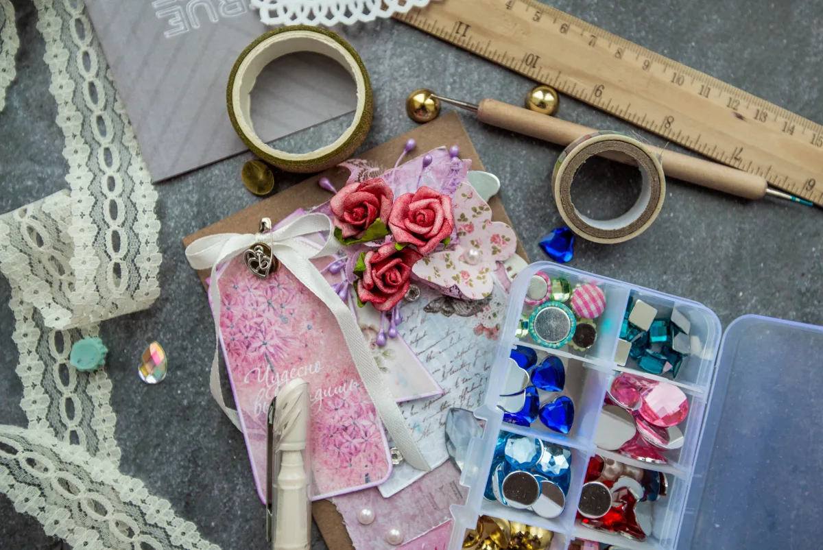 Flat lay of art supplies including pencils, paints, and brushes arranged on a table